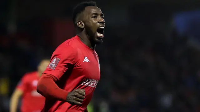 Amari-Morgan Smith celebrating scoring a goal for Kidderminster Harriers with his right fist clenched 