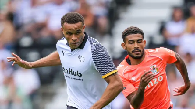 Derby County's Carlton Morris and Coventry City's Kaine Kesler-Hayden playing during their Championship match