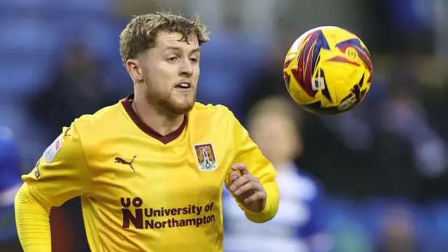  Liam McCarron watches the ball closely as he is about to control it during a match for Northampton Town