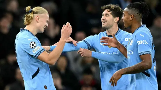 Manchester City players celebrate with Erling Haaland