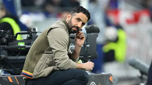 Ruben Amorim crouches on touchline