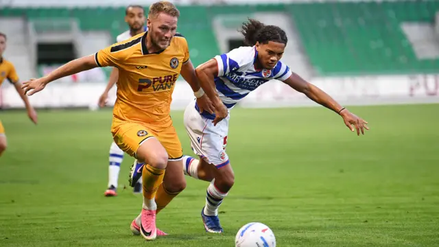 Cameron Norman battles for the ball in Newport County's friendly against Reading