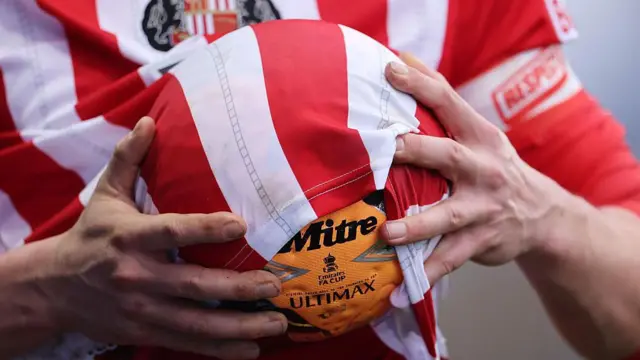 Detailed view as a Sunderland player uses their shirt to wipe the FA Cup ball 