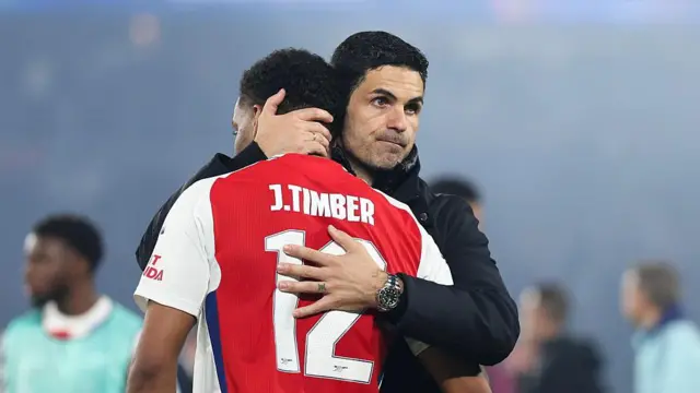 Mikel Arteta comforts Jurrien Timber after Champions League defeat