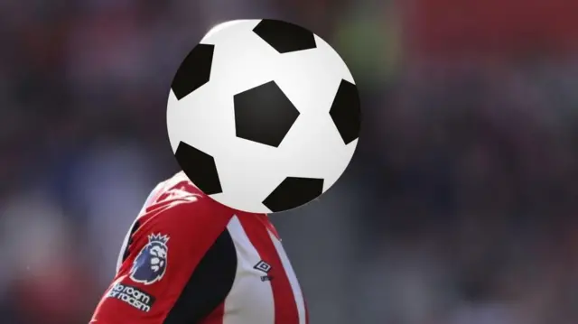 Brentford player hidden behind a football