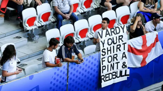  An England fan holds up a sign asking Jamie Vardy for his shirt in exchange for a pint and a Red Bull during Euro 2016