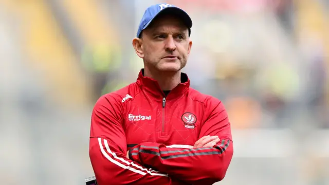 Ciaran Meenagh watches on from the sidelines with arms folded