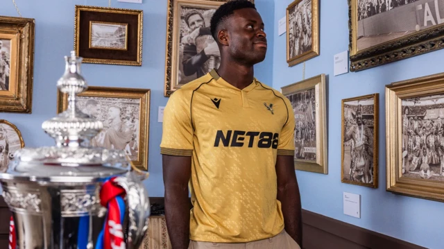 Marc Guehi wearing Crystal Palace's new gold shirt