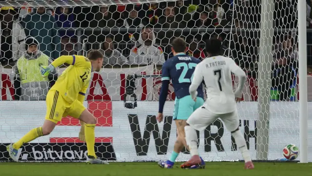 Abdul Fatawu in an all white Ghana kit scores against Germany