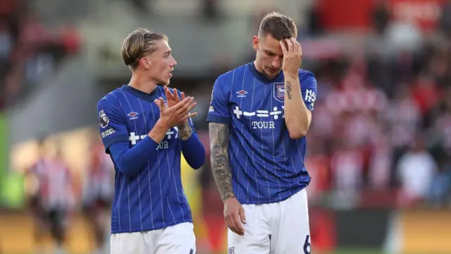 Luke Woolfenden and Jack Clarke of Ipswich Town leave the pitch at the end of the Premier League match between Brentford FC and Ipswich Town FC.