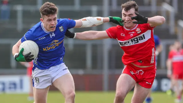 Cavan’s Dara McVeety is challenged by Derry's Diarmuid Baker