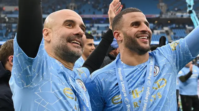 Pep Guardiola and Kyle Walker smile after winning a Premier League title