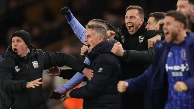 Kieran McKenna and fellow Ipswich staff celebrate the winning goal at Wolves