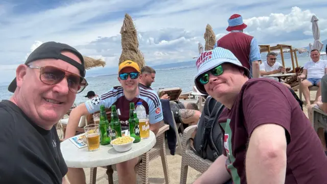 Aston Villa fan Sam with his brother and friend