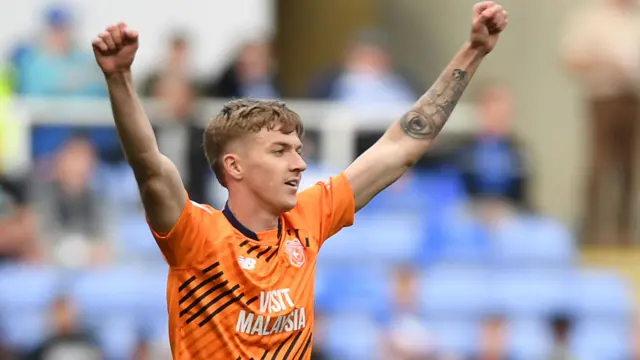 Joel Bagan with his arms aloft