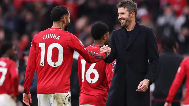 Michael Carrick shakes hands with Matheus Cunha 