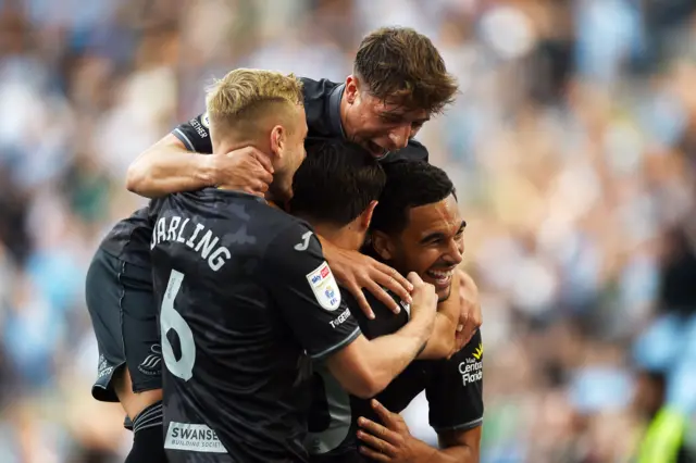  Liam Cullen of Swansea City celebrates with team mates after he scores the first goal of the game at Coventry