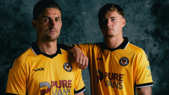Newport County players Harrison Biggins and James Crole wearing the club's new home shirt 