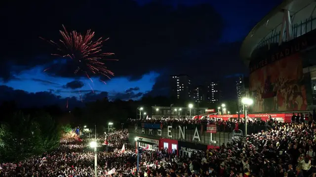 Fans celebrate outside the Emirates
