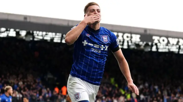 Liam Delap blows a kiss to celebrate his second goal for Ipswich against Aston Villa