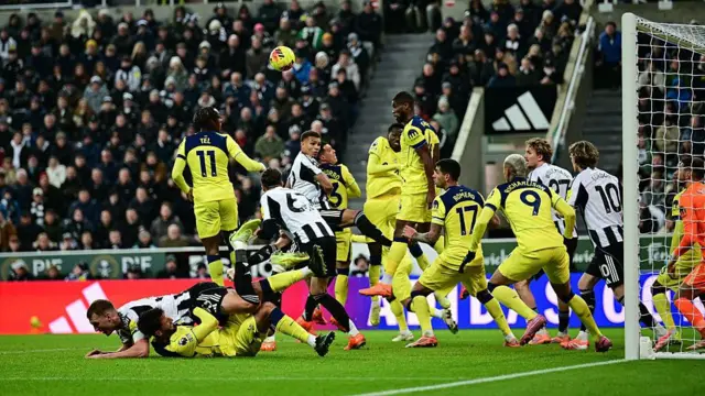Dan Burn is pulled to the ground as Newcastle play Tottenham