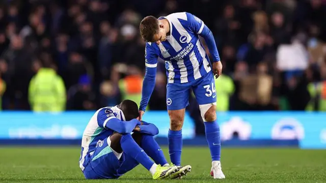Yankuba Minteh of Brighton & Hove Albion reacts at full time while being consoled by Joel Veltman 