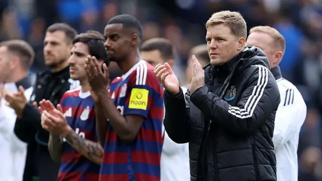 Eddie Howe and his Newcastle players applaud after a draw at Brighton