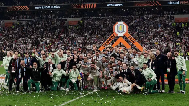 Aston Villa's players and staff celebrate with the Europa League trophy