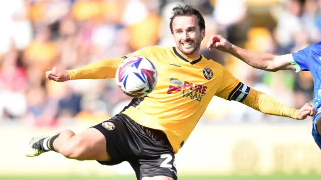 Aaron Wildig of Newport County strikes the ball