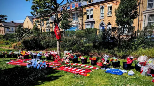 Scarves around a tree outside Anfield