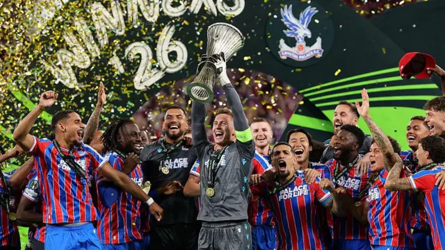 Crystal Palace keeper Dean Henderson lifts the Europa Conference League trophy