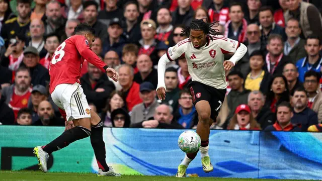 Rio Ngumoha of Liverpool is challenged by Casemiro of Manchester United