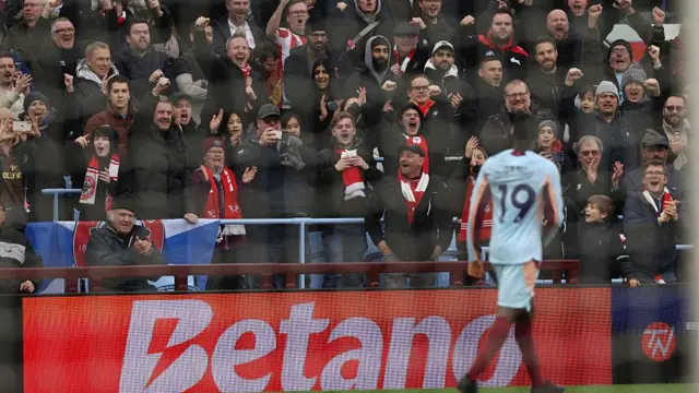 Brentford fans celebrate with Dango Ouattara in the foreground