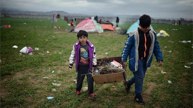 Two boys carry fire wood at the Idomeni camp