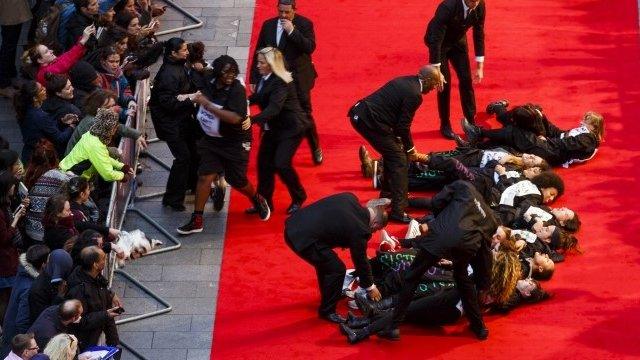 A feminist group Sisters Uncut protesting against cuts to support for victims of domestic violence occupy the red carpet during a protest at the Suffragette premiere