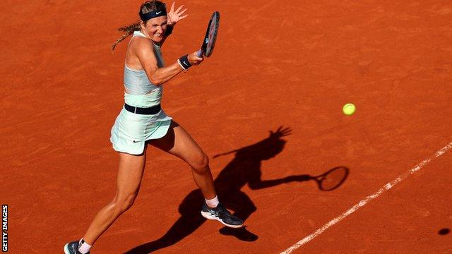 Victoria Azarenka hits a ball