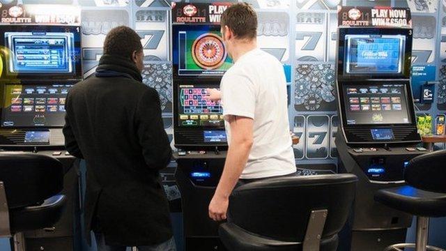 Man playing at fixed-odds betting terminal