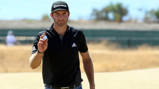 Dustin Johnson holds his ball