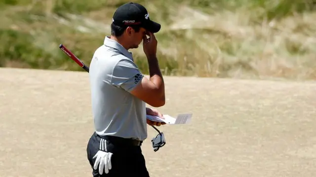 Jason Day puts his hands to his head