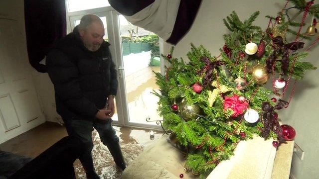 Alan Shaw in his living room with his Christmas tree on its side