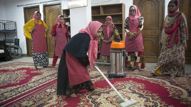 Woman vacuuming carpet