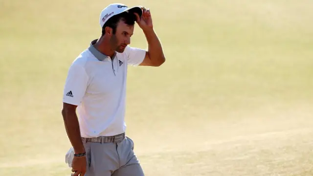 Dustin Johnson walks off the 18th hole