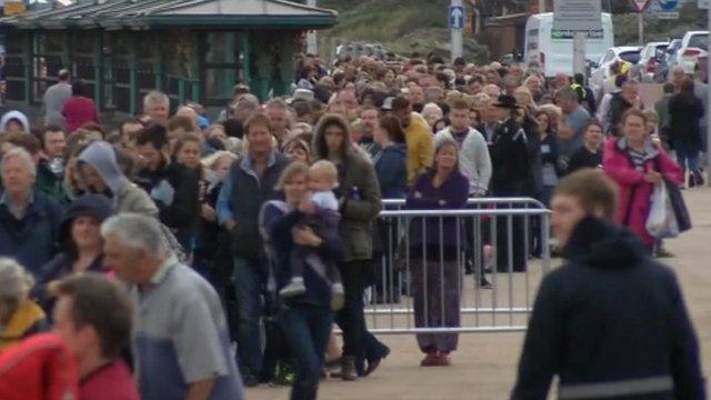 Queue of people waiting to get into Dismaland