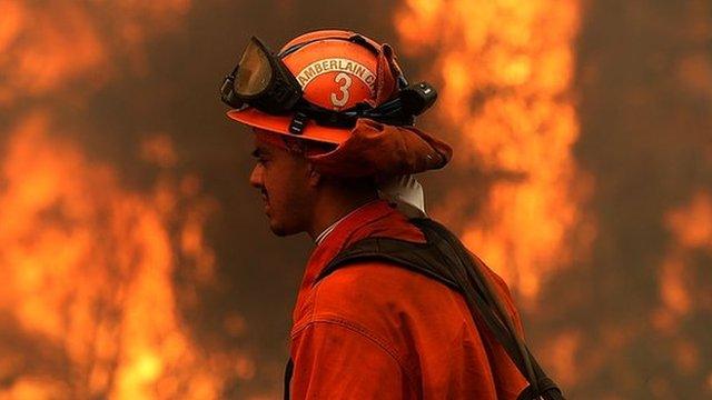 An inmate monitors a backfire during a burn operation to head off the Rocky Fire in August