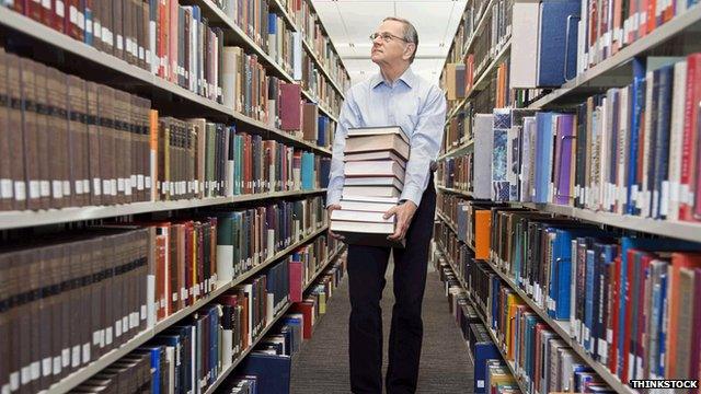 man with books and shelves