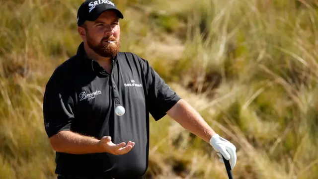 Shane Lowry tosses his ball