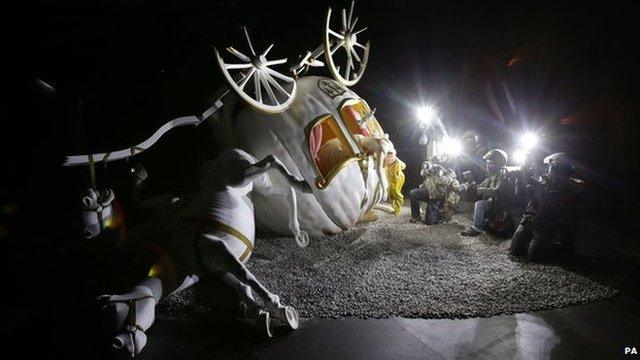 Overturned fairy carriage being photographed