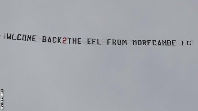 A plane with a banner circles Barrow's ground