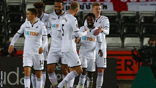 Swansea players celebrate scoring against Notts County