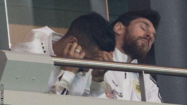 Lionel Messi (right) reacts as Argentina capitulate against Spain